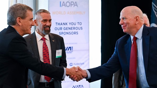 AOPA Senior Vice President of Government Affairs and Advocacy Jim Coon greets FAA Administrator Michael Whitaker during an IAOPA World Assembly meeting in Washington, D.C., on May 8. Photo by David Tulis.
