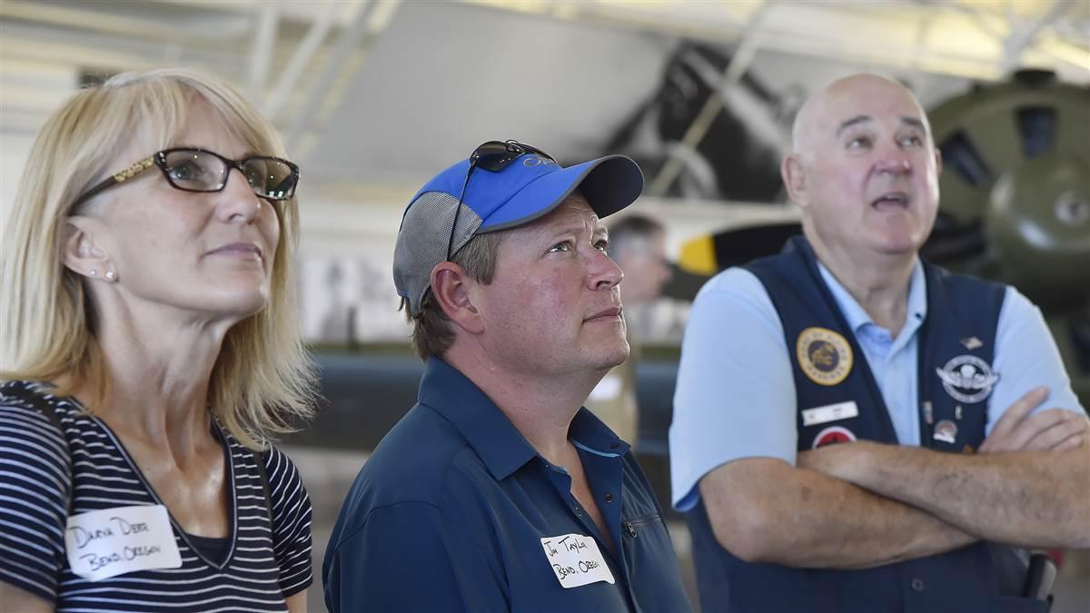 Darva Derr and Jim Taylor listen to Flying Heritage Museum docent John Sommerfeld at Paine Field in Everett, Washington, during a lunch stop for AOPA Bremerton Fly-In attendees participating in a special Boeing VIP tour Aug. 19. Photo by David Tulis.