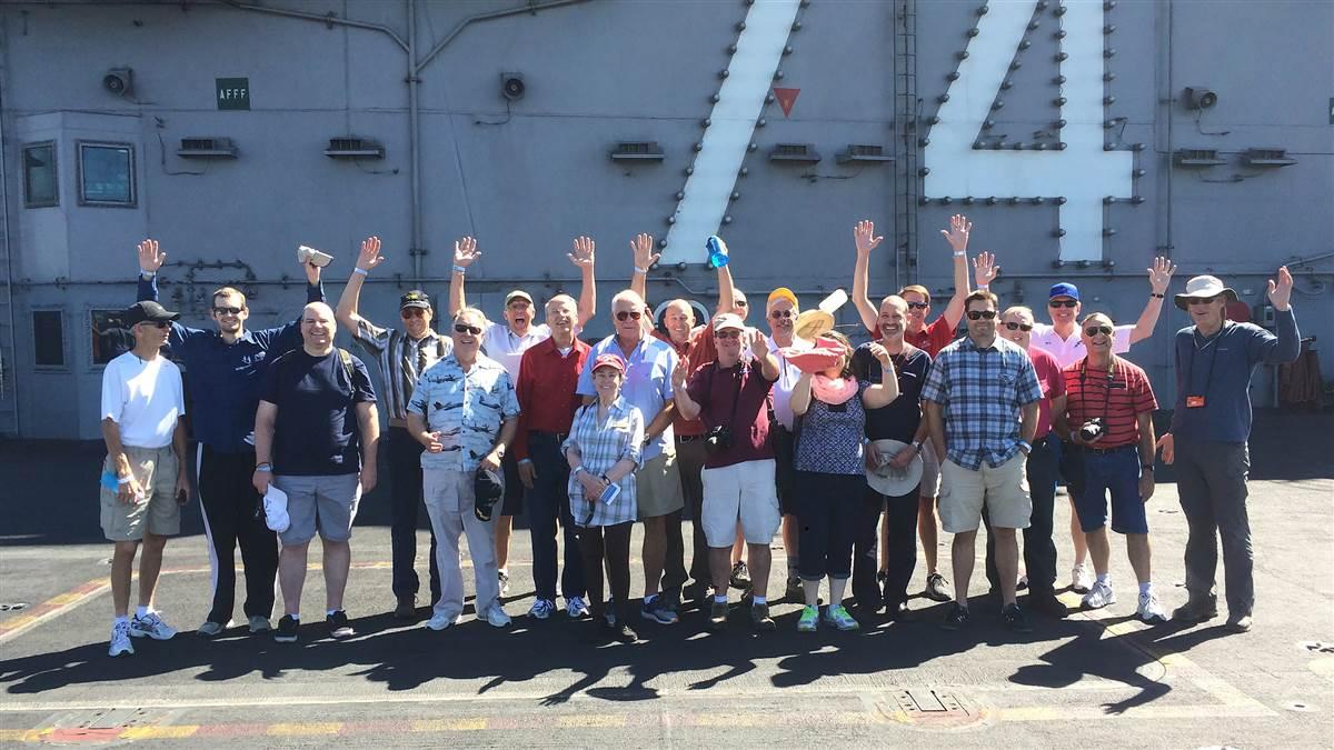 Attendees pose for a photo during a visit to the USS John C Stennis aircraft carrier docked at Naval Base Kitsap during one of two special tours for the AOPA Fly-In at Bremerton, Washington, Aug. 19. Photo by George Perry.