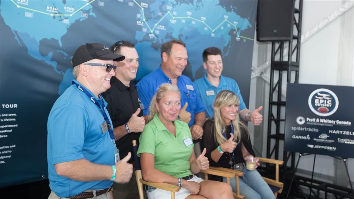 Epic CEO Doug King, at far left, and his staff celebrate the completion of the journey around the world at EAA AirVenture July 26. Photo by Jim Moore.