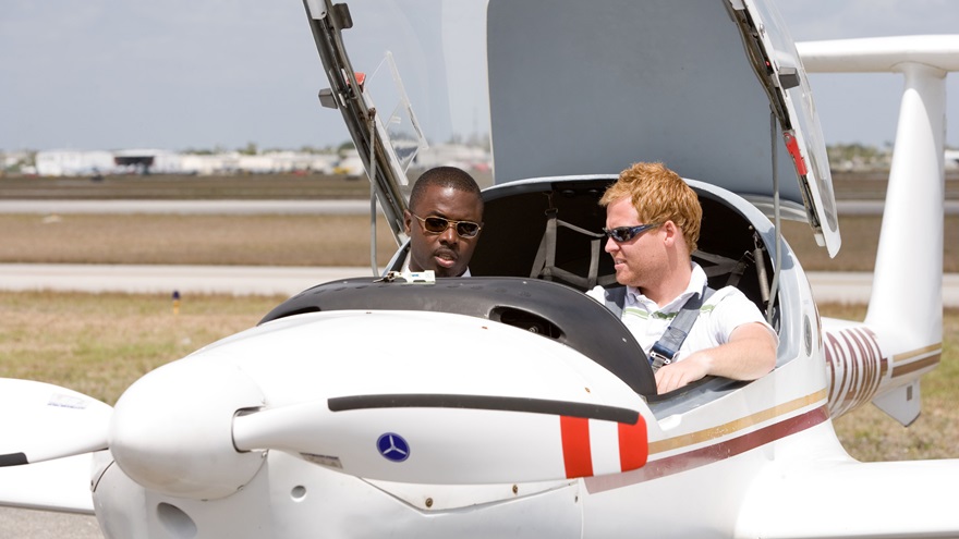 A student pilot works with his instructor.