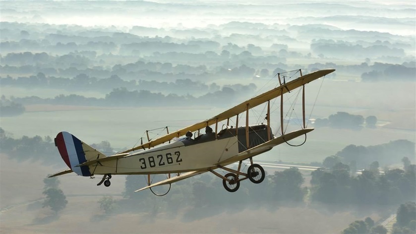 The Friends of Jenny Curtiss JN4 flies above some morning ground fog. Photo by Mike Collins.