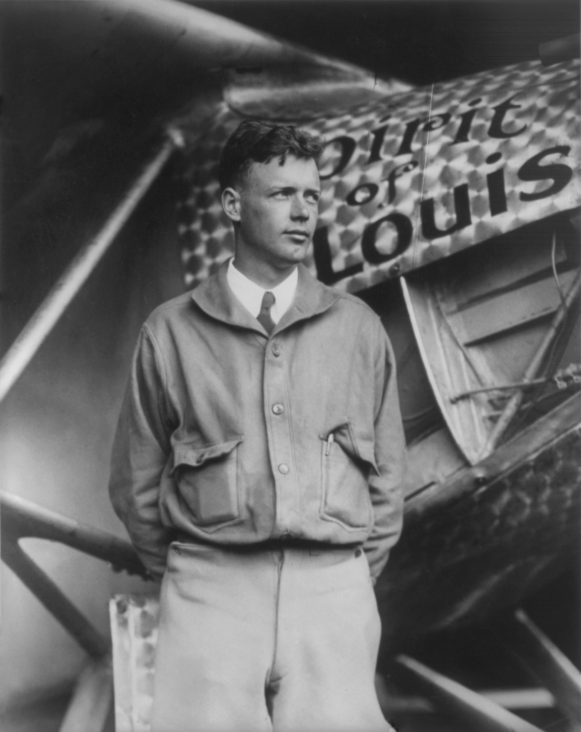 Charles Lindbergh, with Spirit of St. Louis in background. Restored by Crisco 1492 from File:Charles Lindbergh and the Spirit of Saint Louis.tif (removed dust, scratches, including black spots on the wings which may or may not have been there in the original).
