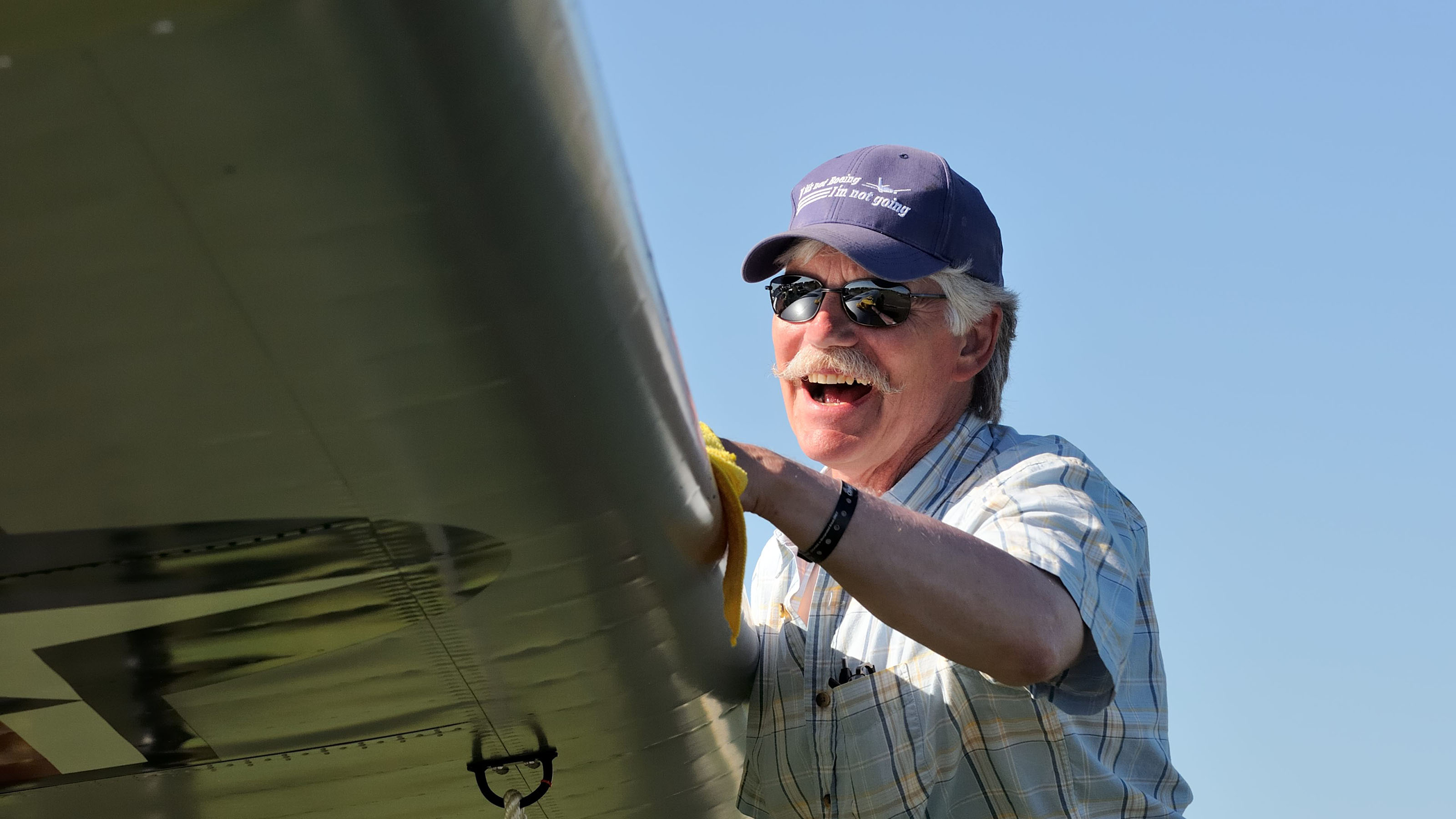 Keith Brunquist of Wasilla, Alaska, polishes the wing of his Boeing YL-15 Scout shortly before it is judged at EAA AirVenture 2017. The unique prototype won Grand Champion: Post World War II.