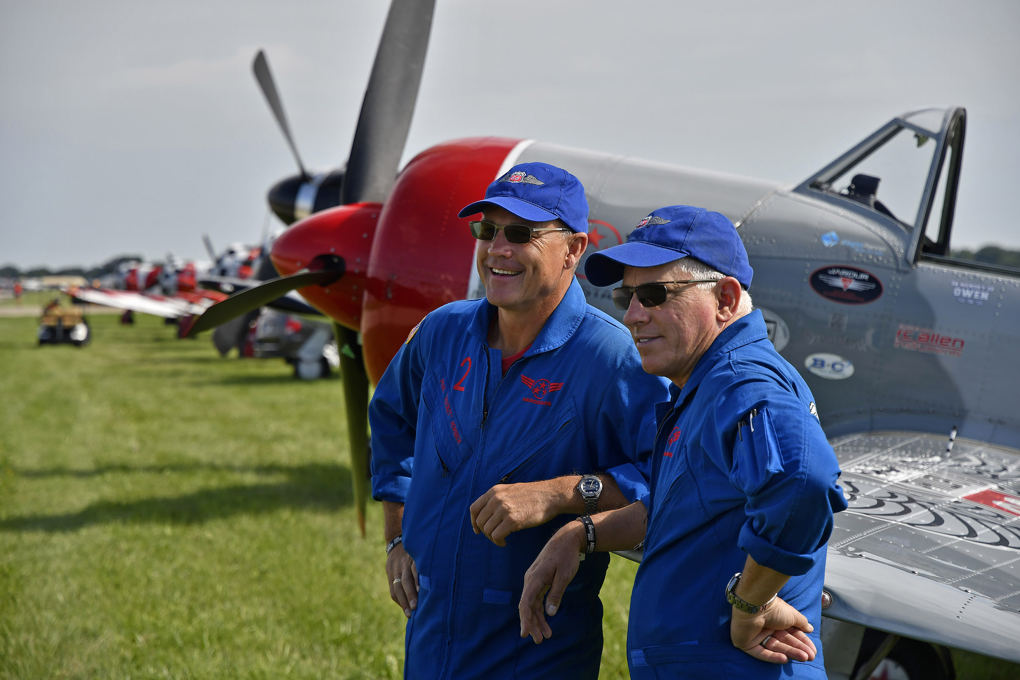 Phillips 66 Aerostars teammates Paul 'Rocket' Hornick and Dave 'Cupid' Monroe smile from the flight line during EAA AirVenture in Oshkosh, Wisconsin. The pilots begin training for the summer air show season in January. Photo by David Tulis.
