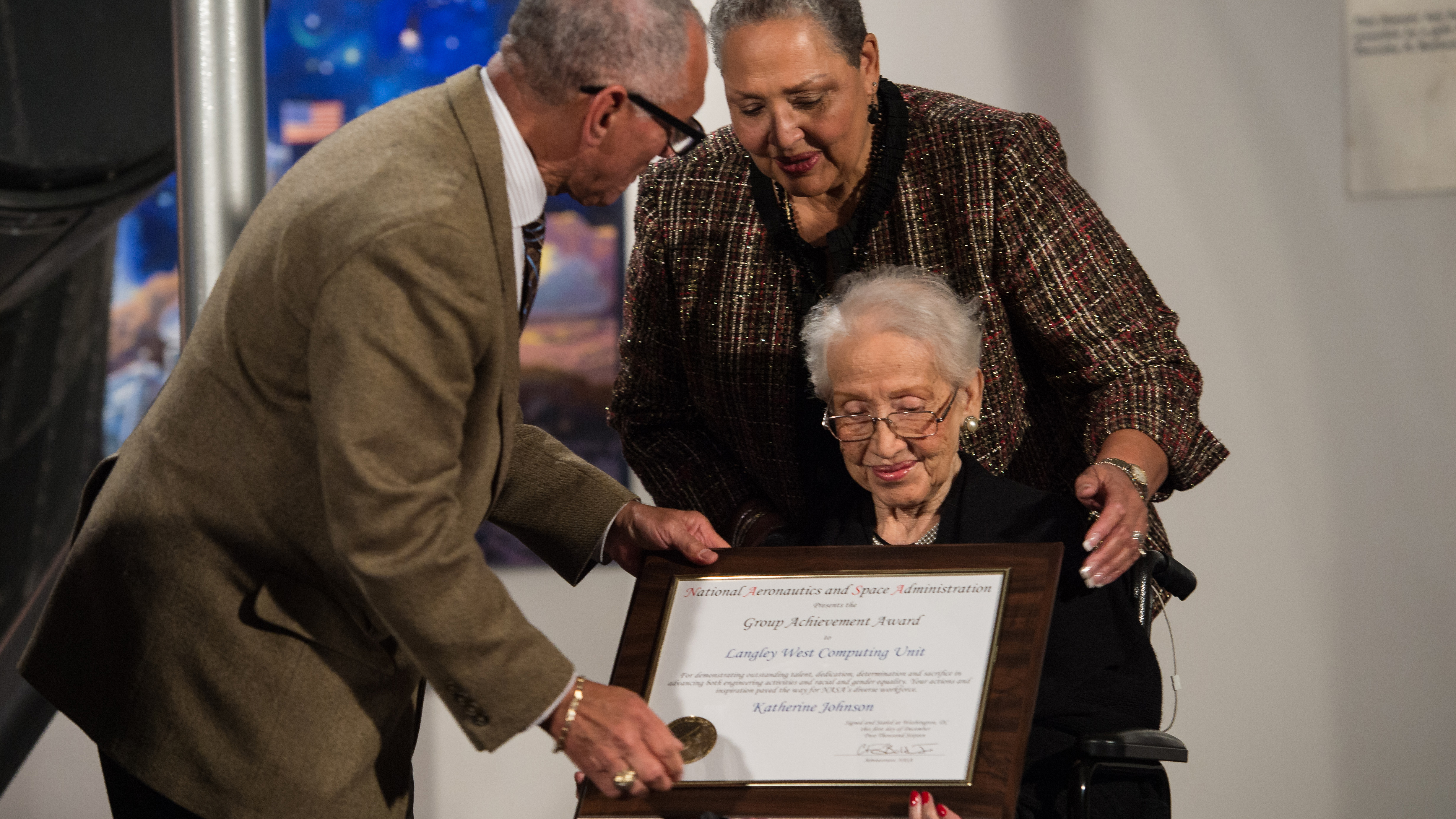 NASA Administrator Charles Bolden presents an award to Katherine Johnson, the African American mathematician, physicist, and space scientist, who calculated flight trajectories for John Glenn's first orbital flight in 1962, at a reception to honor members of the segregated West Area Computers division of Langley Research Center on Thursday, Dec. 1, 2016, at the Virginia Air and Space Center in Hampton, VA. Afterward, the guests attended a premiere of 'Hidden Figures' a film which stars Taraji P. Henson as Katherine Johnson, Octavia Spencer as Dorothy Vaughan, and Janelle Monae as Mary Jackson. Photo Credit: (NASA/Aubrey Gemignani)