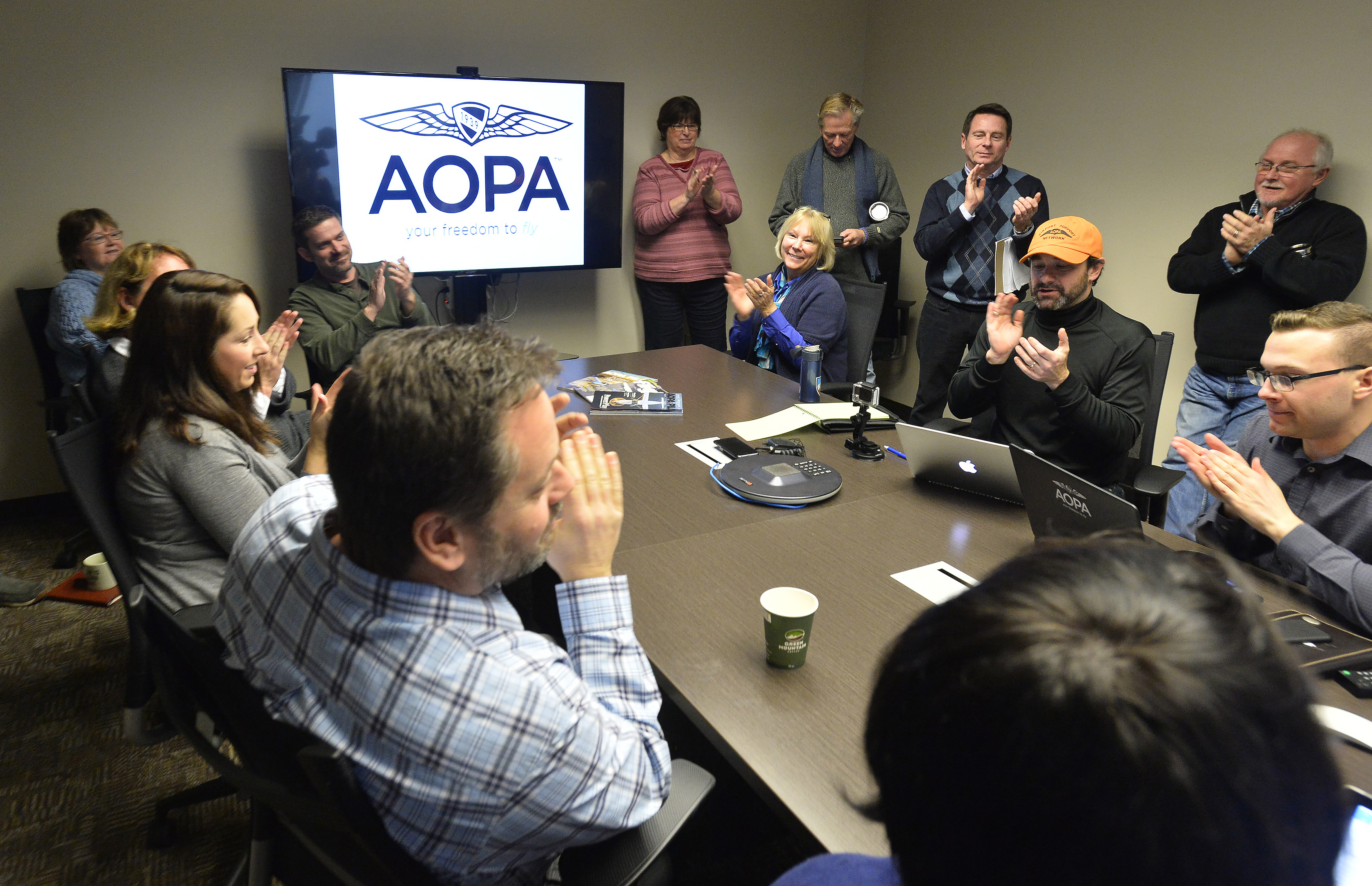 AOPA staff members applaud after an FAA announcement involving the final rule for third class medical reform, called BasicMed, which goes into effect May 1. Photo by David Tulis.