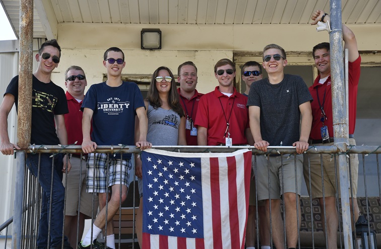Five of the six high school students enrolled in a 30-day outreach camp to earn a private pilot certificate at Liberty University pose for a portrait with their instructors at New London Airport in Lynchburg, Virginia. Photo by David Tulis.