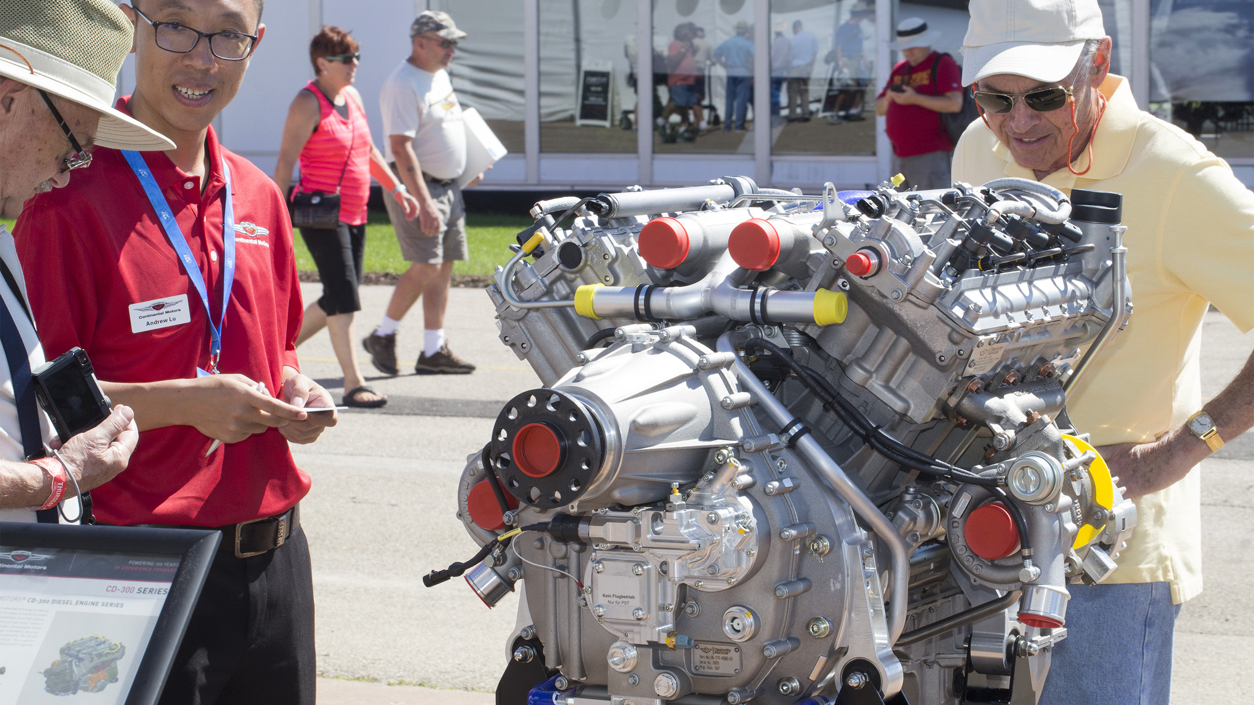 EAA AirVenture attendees talk to a Continental employee and look over the company’s CD-300 diesel engine that recently received European Aviation Safety Agency approval. Photo by Jim Moore.