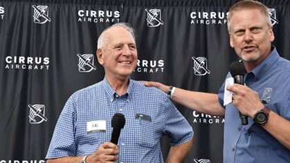 Sporty's Pilot Shop founder Hal Shevers and Cirrus co-founder Dale Klapmeier announce an auction for Shevers' Cirrus Vision Jet delivery position during EAA AirVenture at Wittman Regional Airport in Oshkosh July 23. Photo by David Tulis.