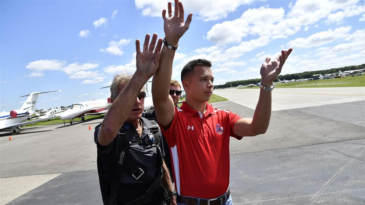 Cameron Jaxheimer, 22, visualizes maneuvers on the ramp with Team Oracle aerobatic performer and mentor Sean D. Tucker during EAA AirVenture. Photo by David Tulis.