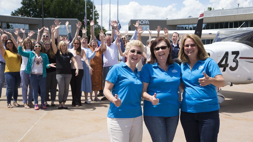 AOPA staff members welcome their colleagues, AOPAngels Luz Beattie, Kathy Dondzila, and Paula Wivell, back to AOPA headquarters in Frederick, Maryland, after the team successfully completed the 2017 Air Race Classic. Photo by Chris Rose.