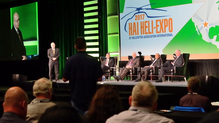 Helicopter Association International (HAI) President Matt Zuccaro, left, and panelists listen to an audience member's question during HAI's symposium on integrating unmanned aircraft systems into the National Airspace System on the opening day of Heli-Expo 2017. Photo by Mike Collins.