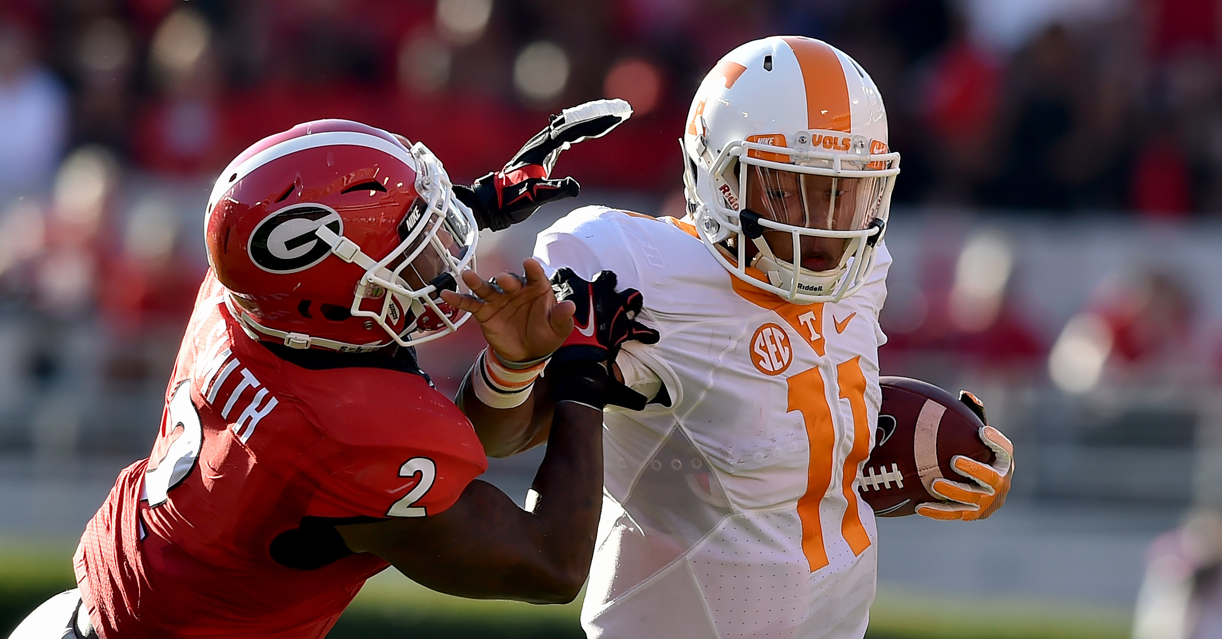 Tennessee quarterback Joshua Dobbs scrambles from Georgia Bulldogs defensive back Maurice Smith during a 2016 NCAA college football game. Photo courtesy of Brant Sanderlin, The Atlanta Journal Constitution.