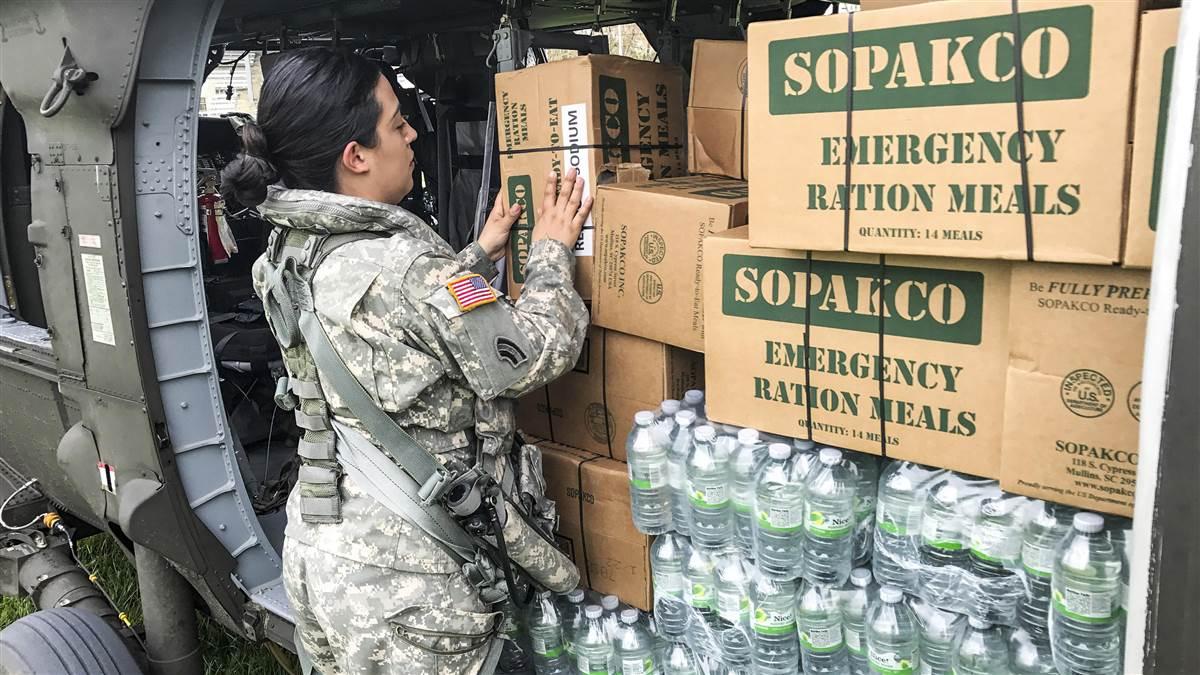 A Puerto Rico National Guard soldier helps transport food and water to the city of Jayuya, Sept. 27. Photo courtesy of Army National Guard Sgt. José Ahiram Díaz-Ramos.