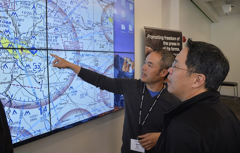 San Francisco-based multimedia journalist Kiet Do learns how to read an aviation chart during a breakout session at a University of Georgia drone journalism workshop. Photo by David Tulis.                                                                                                         
