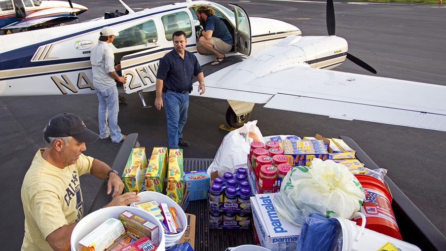 General aviation charity organizations coordinate relief flights after natural disasters, such as the Bahamas Habitat mission pictured here in the wake of Hurricane Irene in 2011. Pilots should work with these aviation organizations instead of flying alone.