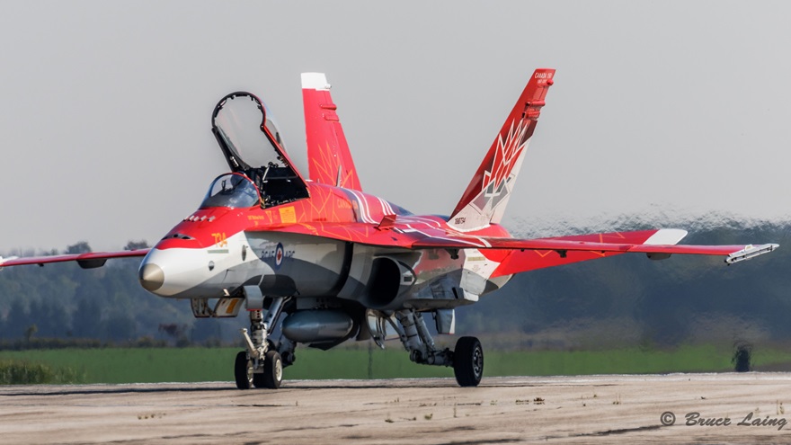 A Royal Canadian Air Force CF18 sits on the tarmac at Airshow London painted in the brilliant red of the maple leaf and Canada 150 logo to honor the celebration of Canada’s birthday. This show was the final Canadian stop for the aircraft and demo team. Photo by Bruce Laing.