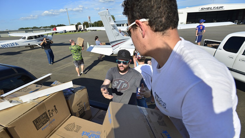 Volunteers load food staples into general aviation aircraft at an Ocala International Airport supply area as part of a relief effort to help those affected by Hurricane Irma in 2017. Photo by David Tulis.
