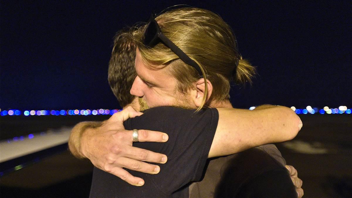 Hurricane Irma evacuee Chris Norton hugs his brother after arriving via general aviation aircraft at Lakeland Linder Regional Airport, a major staging area for relief missions, Sept. 14. Norton and his two dogs survived the powerful storm's blow to St. John, a former island paradise that was destroyed by fierce winds, tides, and rain. Photo by David Tulis.