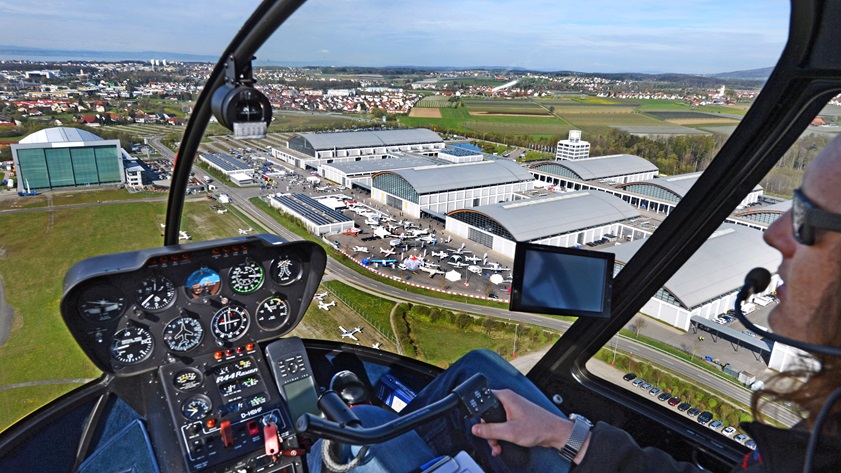 A helicopter provides an aerial view of the convention buildings and static display during AERO 2012. Photo courtesy of AERO Friedrichshafen.