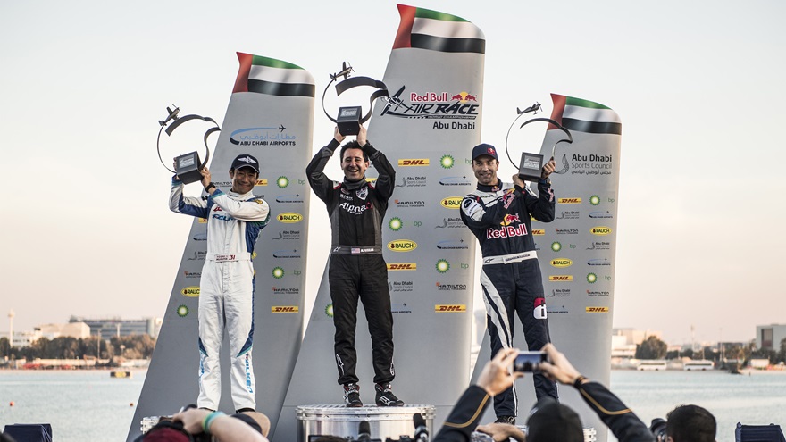 Michael Goulian of the United States (center) celebrates with Yoshihide Muroya of Japan (left) and Martin Sonka of the Czech Republic (right) during the Award Ceremony at the first round of the Red Bull Air Race World Championship in Abu Dhabi, United Arab Emirates on February 3, 2018. // Joerg Mitter / Red Bull Content Pool