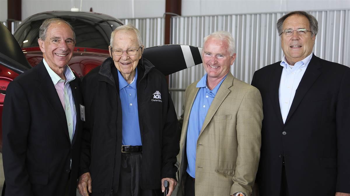 Former AOPA President Phil Boyer, charter member Earle Blomeyer, AOPA President Mark Baker, and former AOPA President Craig Fuller celebrate AOPA's seventy-fifth anniversary at Wings Field in 2014. AOPA file photo. 