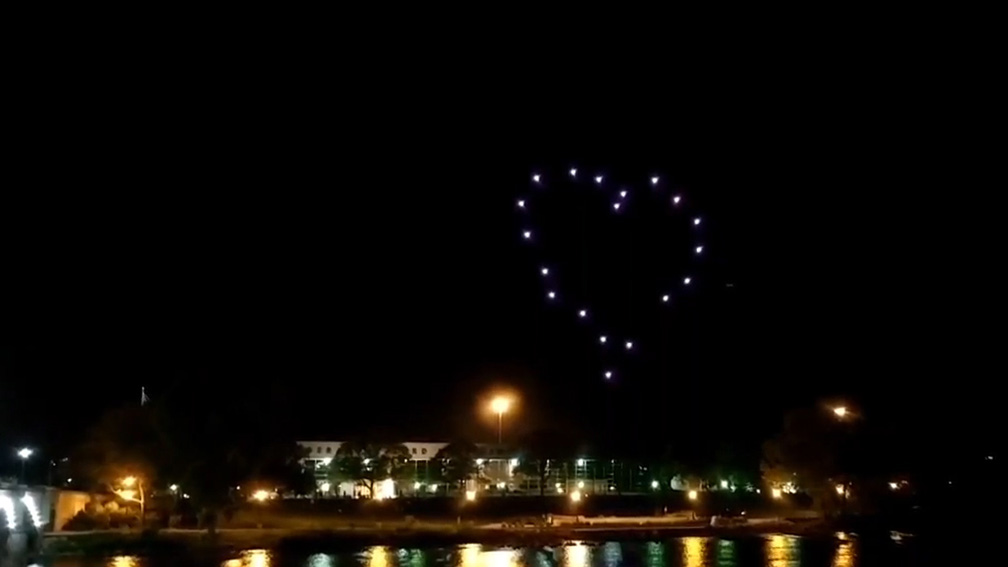 Unmanned aircraft fitted with LED lights create a heart shape in the sky during a Great Lakes Drone Company show in 2017. Photo courtesy of the Great Lakes Drone Company. 
