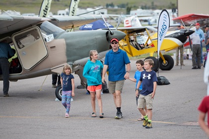 A family walks through the static display area during the AOPA Fly-In at Missoula International Airport, in Missoula, Montana. Photo by Mike Fizer.