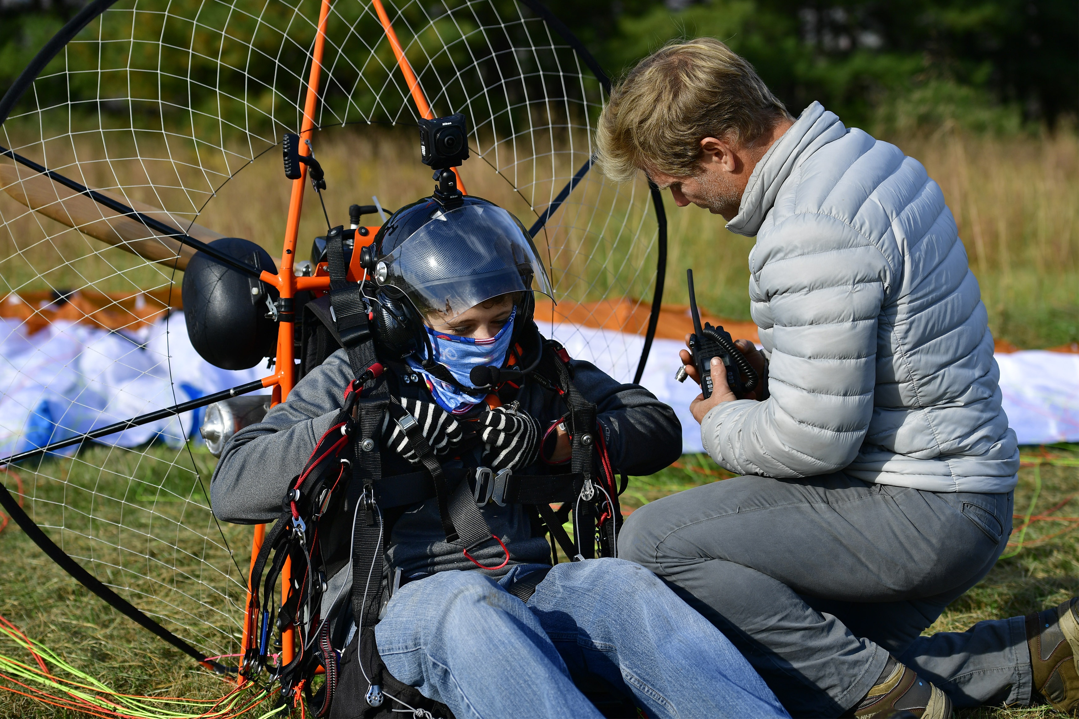 Powered paraglider pilot Henry Scott and his father, Jens, prepare for a powered paragliding flight from a grass strip in Lovettsville, Virginia. Photo by David Tulis.