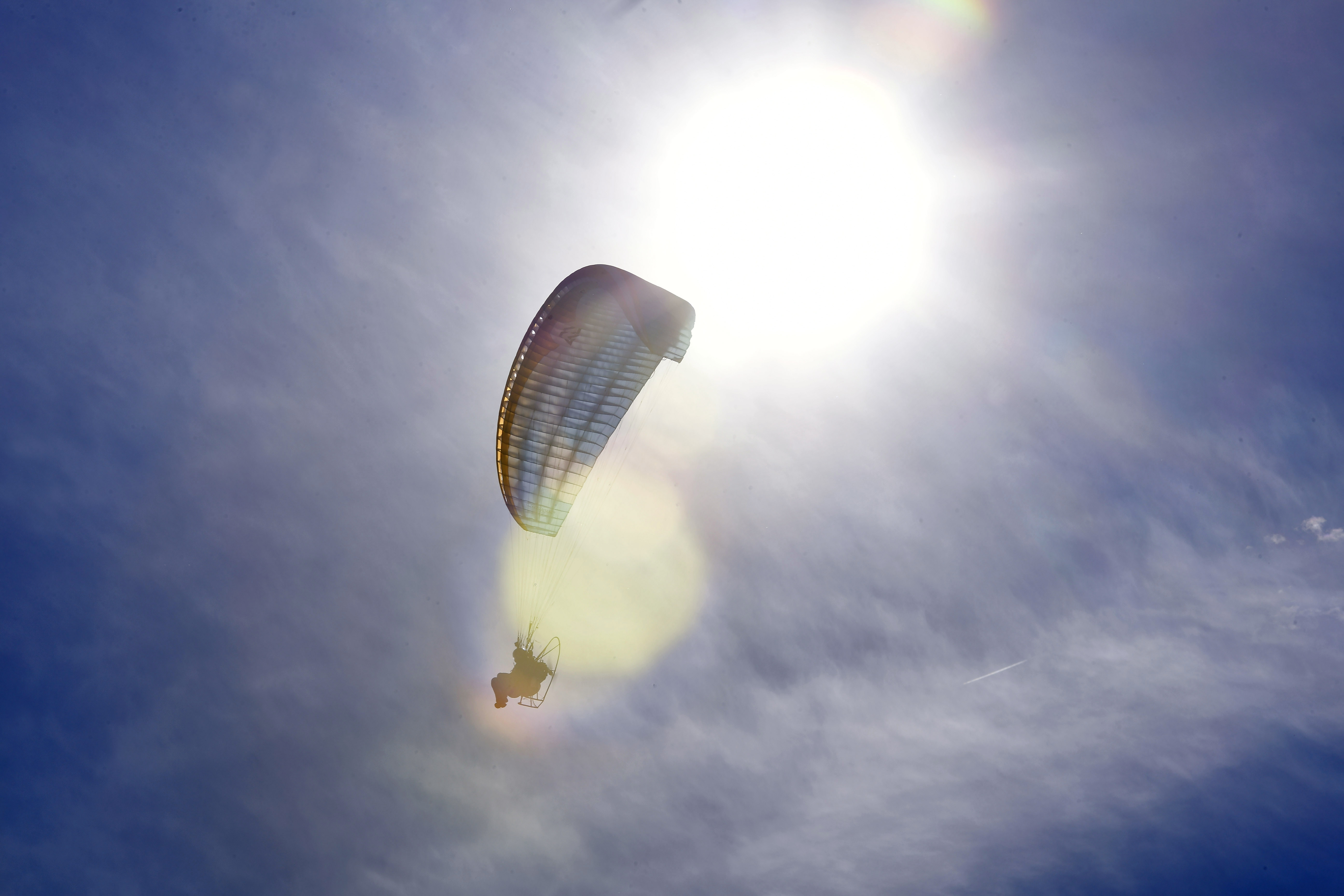 The sun frames powered paraglider pilot Henry Scott. Photo by David Tulis.