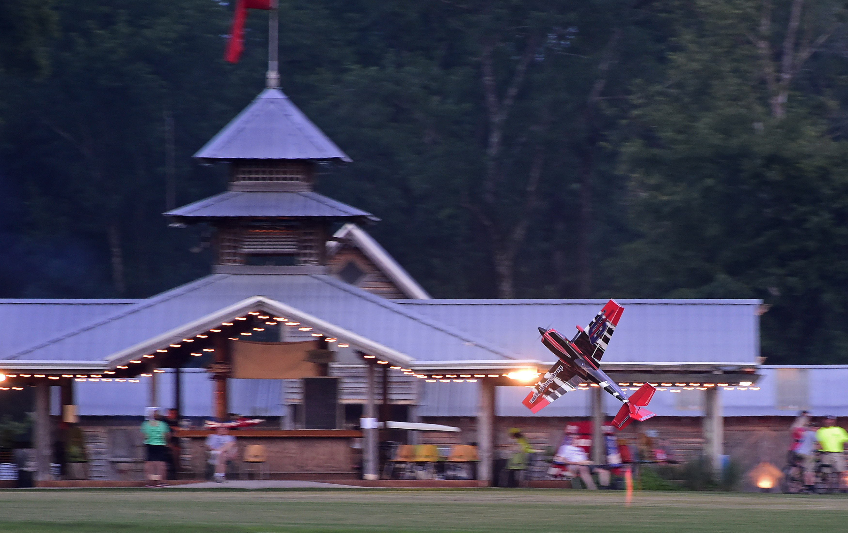 A remote-controlled aerobatic demonstration takes place near the main gazebo during the Young Aviators Fly-In at Triple Tree Aerodrome June 8 to 10 in Woodruff, South Carolina. Photo by David Tulis.