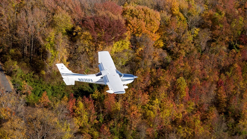 A Cessna 182 Skylane flies over fall colors in Maryland. Photo by Mike Fizer.