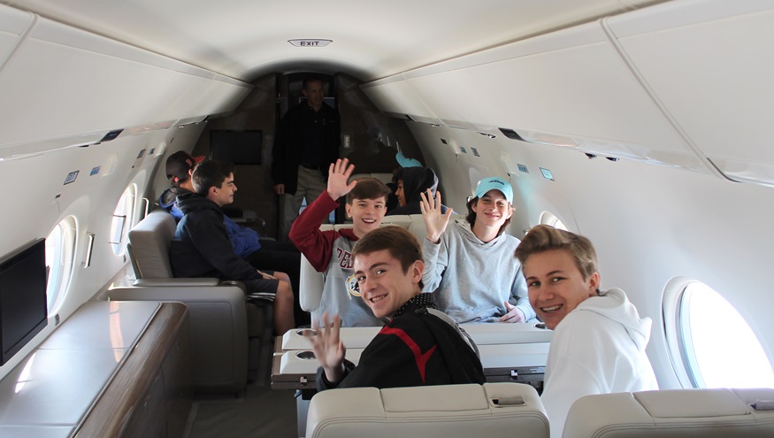 Students sit inside a business jet during the annual Aviation Education and Career Expo at Leesburg Executive Airport in Virginia. Photo courtesy of Alimond Photography, PropJet Aviation.