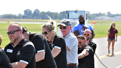 An AOPA employee team--including AOPA President Mark Baker, in tan shirt--competes in Special Olympics Illinois' Southern Illinois Plane Pull. Photo by Mike Collins.