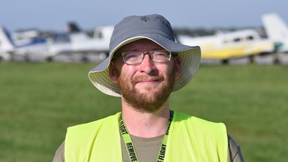 Craig Blumer of Springfield, Illinois--a pilot, flight instructor, and air traffic controller--rode his bicycle 280 miles to AOPA's 2018 Carbondale, Fly-In where he volunteered marshalling aircraft. Photo by Mike Collins.