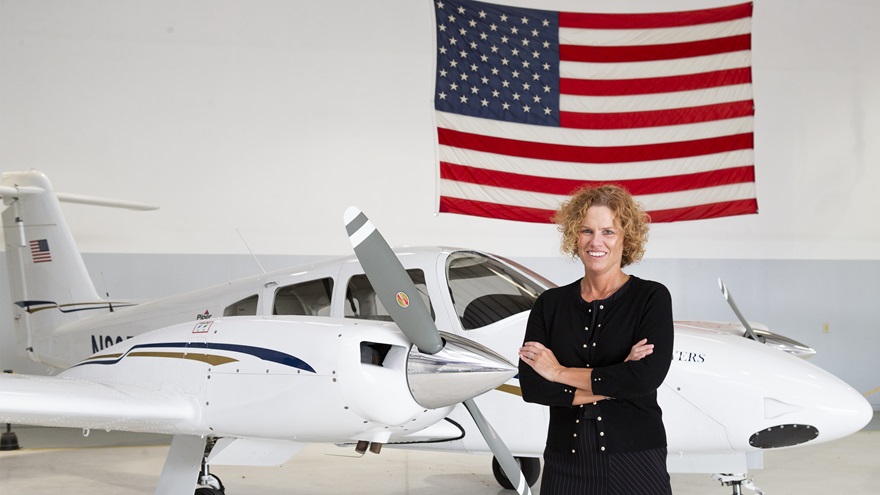 Jill Cole, the president of American Flyers, stands near a 2019 Piper PA-44 Seminole that is part of the 40-aircraft fleet. Photo courtesy of American Flyers.