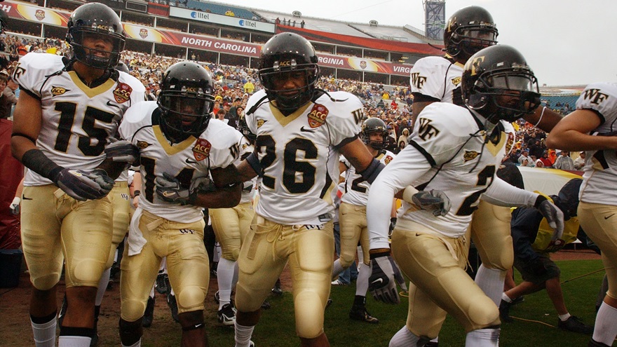 The Wake Forest Demon Deacons run onto the field before facing the Georgia Tech Yellow jackets during an ACC Football Championship game. Photo By David Tulis.
