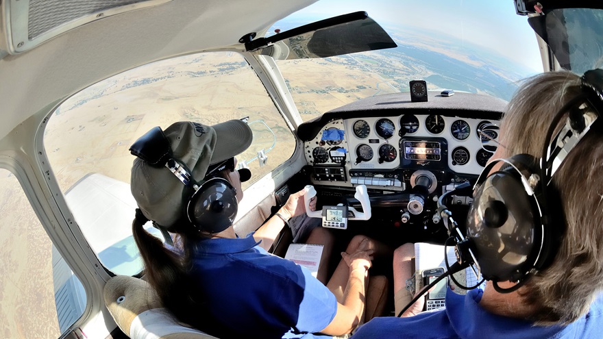 Kim Purcell, left, and Rob Kirkpatrick look for a checkpoint during the 2017 Hayward Air Rally. Funds raised by the annual pilot proficiency event will send two students to the EAA Air Academy in July 2020. Photo by Mike Collins.
