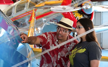 Private pilot Felix Lopez teaches his daughter Vivian about the fabric-and-tube design of a Boeing Stearman at Triple Tree Aerodrome in Woodruff, South Carolina. Photo by David Tulis.