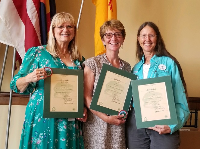 Three of seven AOPA members inducted into the International Forest of Friendship. Left to right: Myra J. Bugbee, Ellen Herr, and Terry Carbonell. Photo courtesy Terry Carbonell