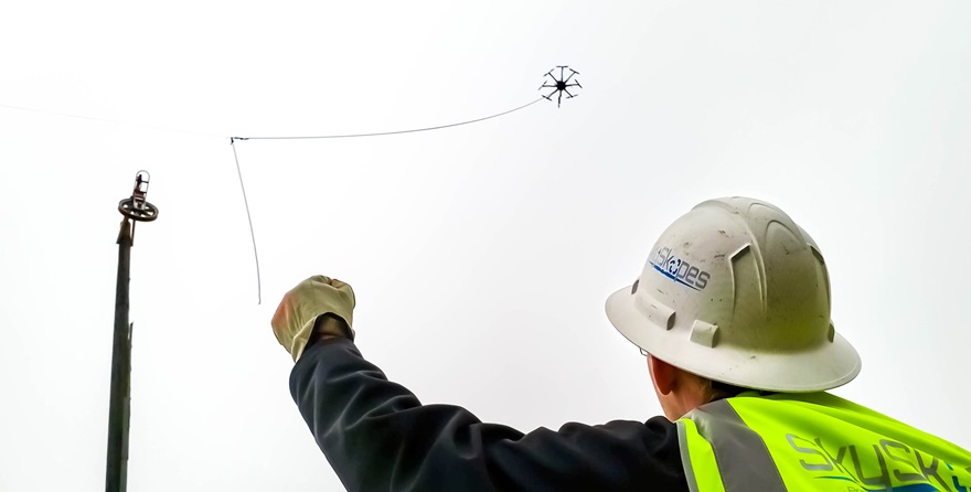 During a line string, SkySkopes employee Cory Vinger relays information using hand signals to the drone pilot flying the "line bird," in this case a FreeFly Alta 8. Photo courtesy of SkySkopes.