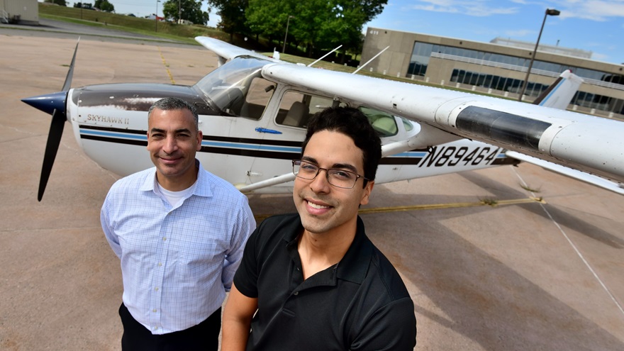 Some 19 years ago, designated pilot examiner Sharif Hidayat, left, made a career day presentation to a seven-year-old Brandon Lagos. On Aug. 10, 2019, he administered a private pilot checkride to Lagos, right. Photo by Mike Collins. 