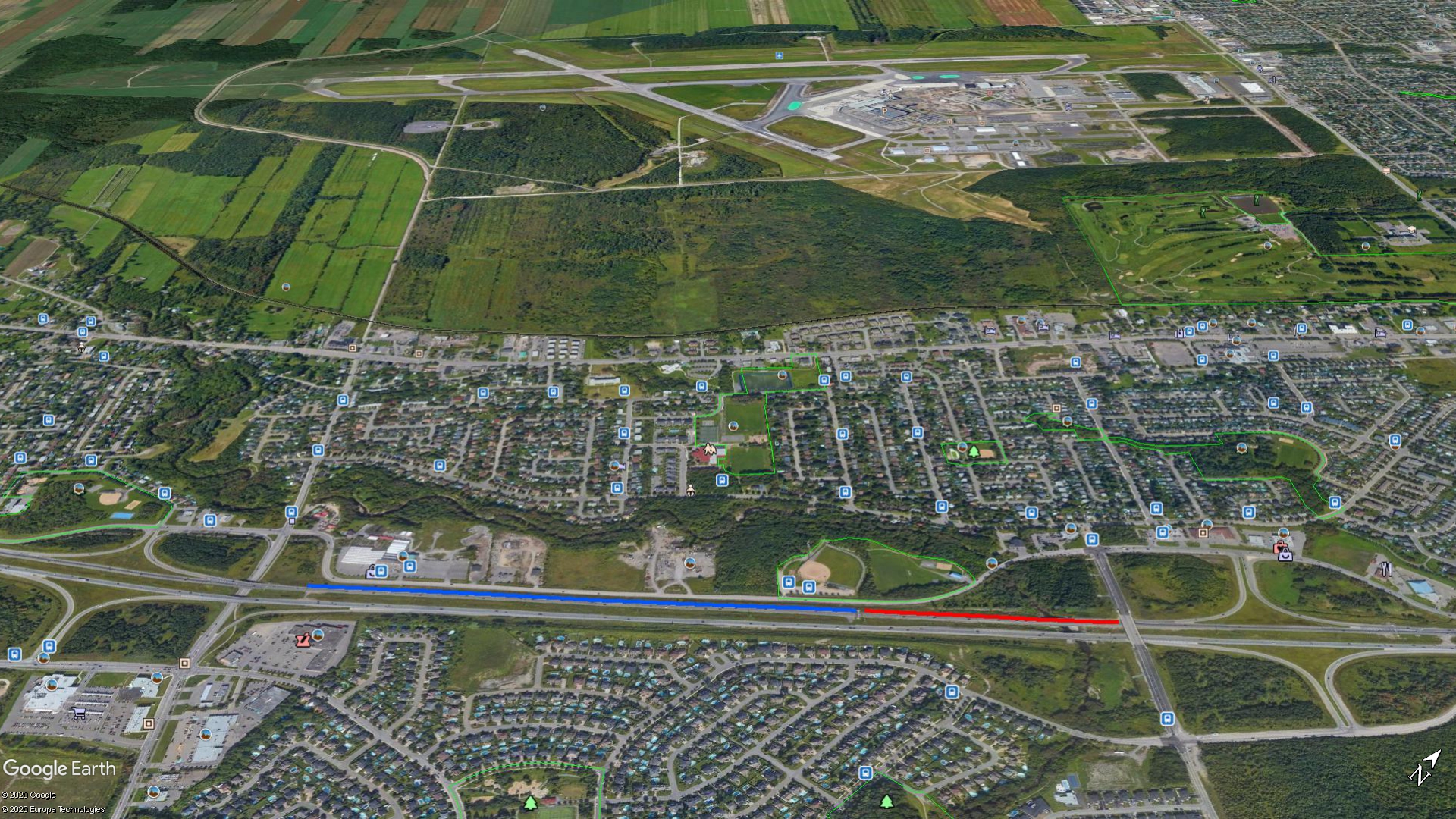 The red line added to this Google Earth image is 1,360 feet long and covers the distance between a bridge and a highway sign that figures in a remarkable emergency Landing on April 16 in Quebec City, Canada. The blue line, just over 3,000 feet long, extends from that sign to the beginning of the off-ramp where the Piper Cherokee was able to move to the side of the road and park.