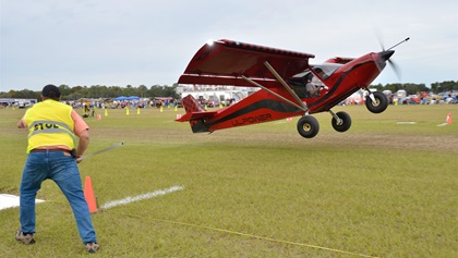 Jack Klein of Little Rock, Arkansas, marks the takeoff spot of a STOL aircraft that got airborne in less than 75 feet. The demonstration of extreme aircraft performance capabilities thrilled hundreds of spectators throughout the two-day event. Photo by Chris Eads.