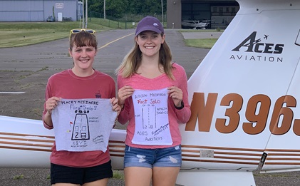 Sisters Macey, left, and Allison Mesinere hold pieces of their cut T-shirts after they soloed on the same day at Beaver County Airport in Pennsylvania. Photo courtesy of Eric Stormfels, ACES Aviation.                                                   