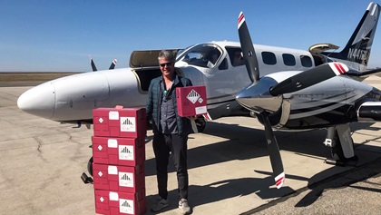 Martti Matheson, co-owner of the Cessna 441 Conquest II that led the general aviation mission to the Mayo Clinic, loads the critical COVID-19 test samples into the aircraft for its daily flight to Minnesota. Photo courtesy of Kirk Walters.