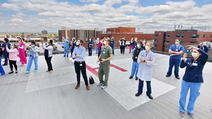Wearing masks to reduce the spread of the coronavirus, doctors, nurses, and staff from the University of Rochester Medical Center in Rochester, New York, watch the Operation Thanks from Above overflight May 16 from the vantage point of a rooftop heliport. Photo by Tetamore Photographic.
