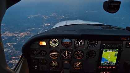 As dusk turned to dark, it was time for weary pilots to call it a night. When flying for enjoyment or personal travel, there is no reason to push through fatigue. Two hours from Oshkosh, a descent into Toledo, Ohio, for the night was imminent. Photo by Chris Eads.
