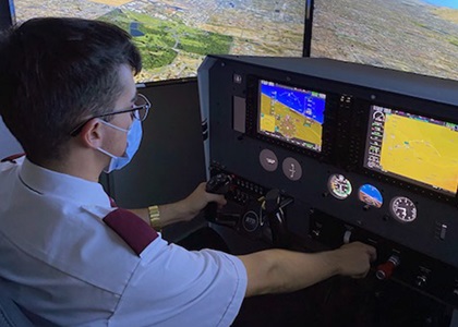 A student tries out a reconfigurable training device from Frasca International during a road show introducing the technology at flight training operation locations. Photo courtesy of Frasca International. 